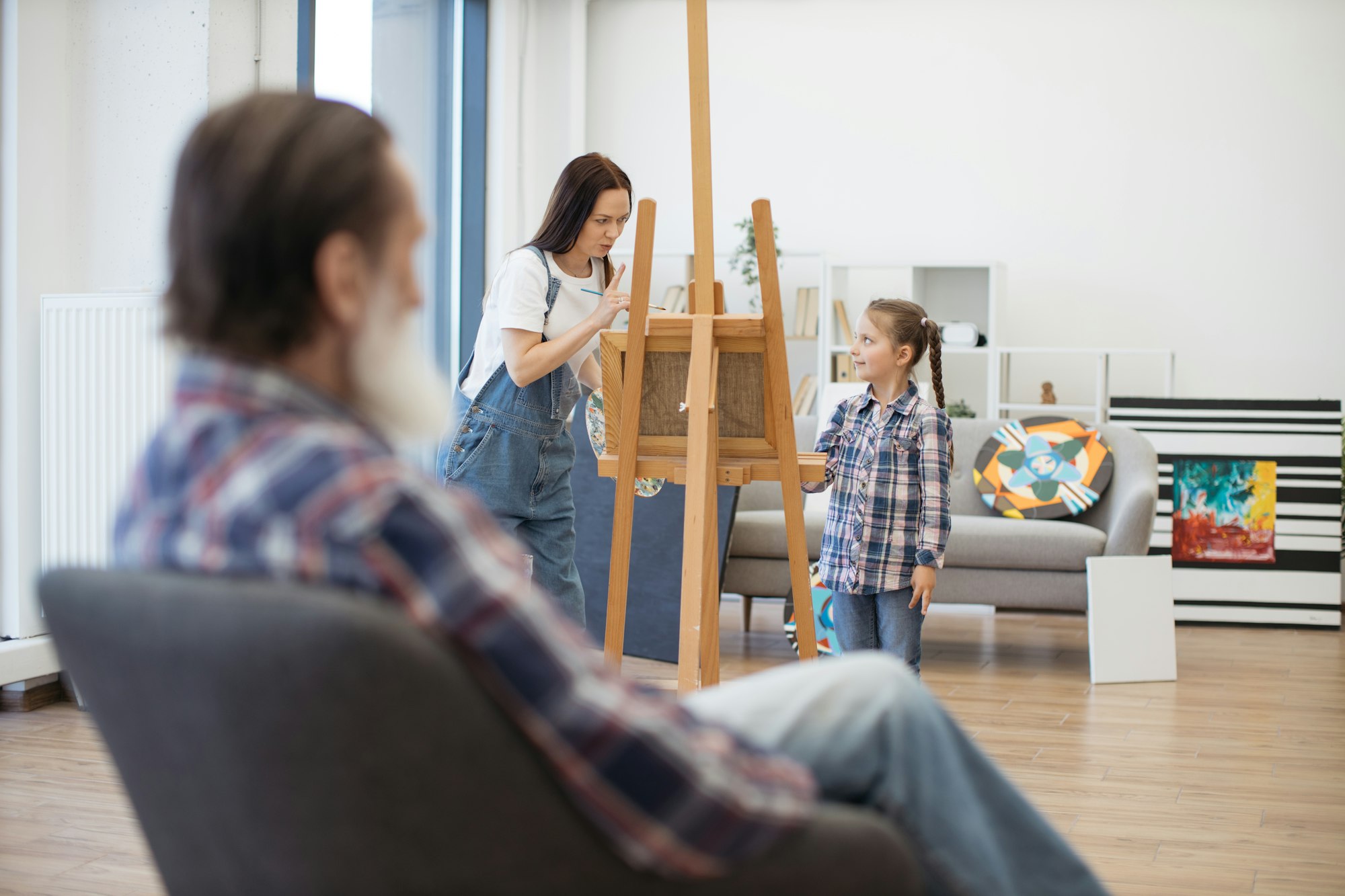 Parent asking girl being cautious while drawing grandpa