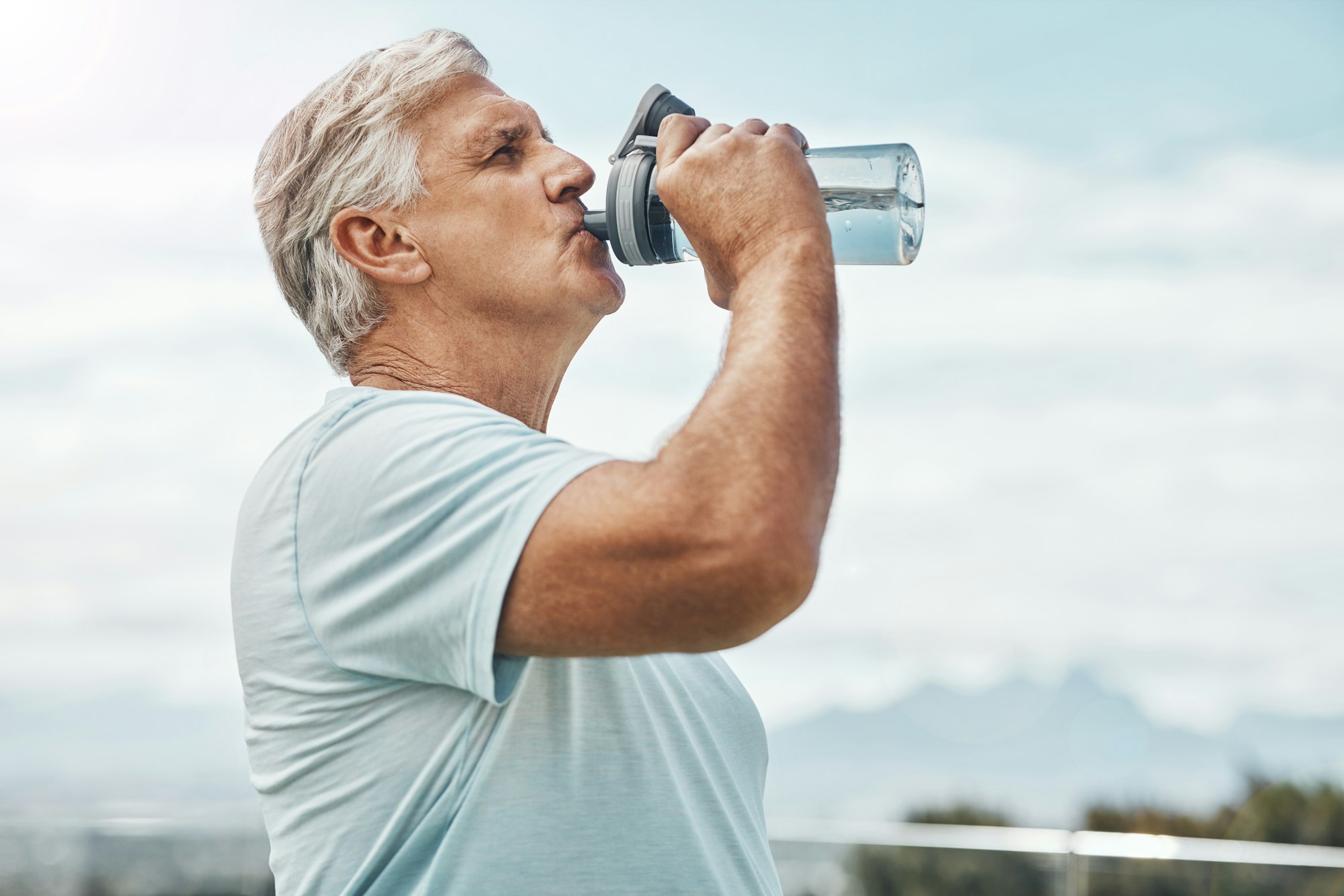 Senior man, fitness and drinking water for hydration or thirst after workout, exercise or training